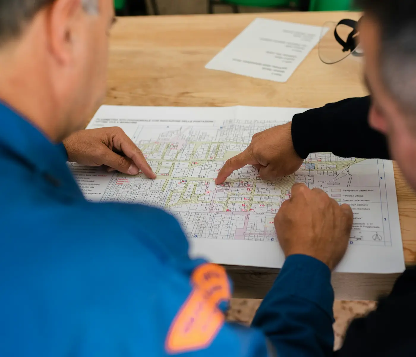 Two engineers working through a site drawing together.