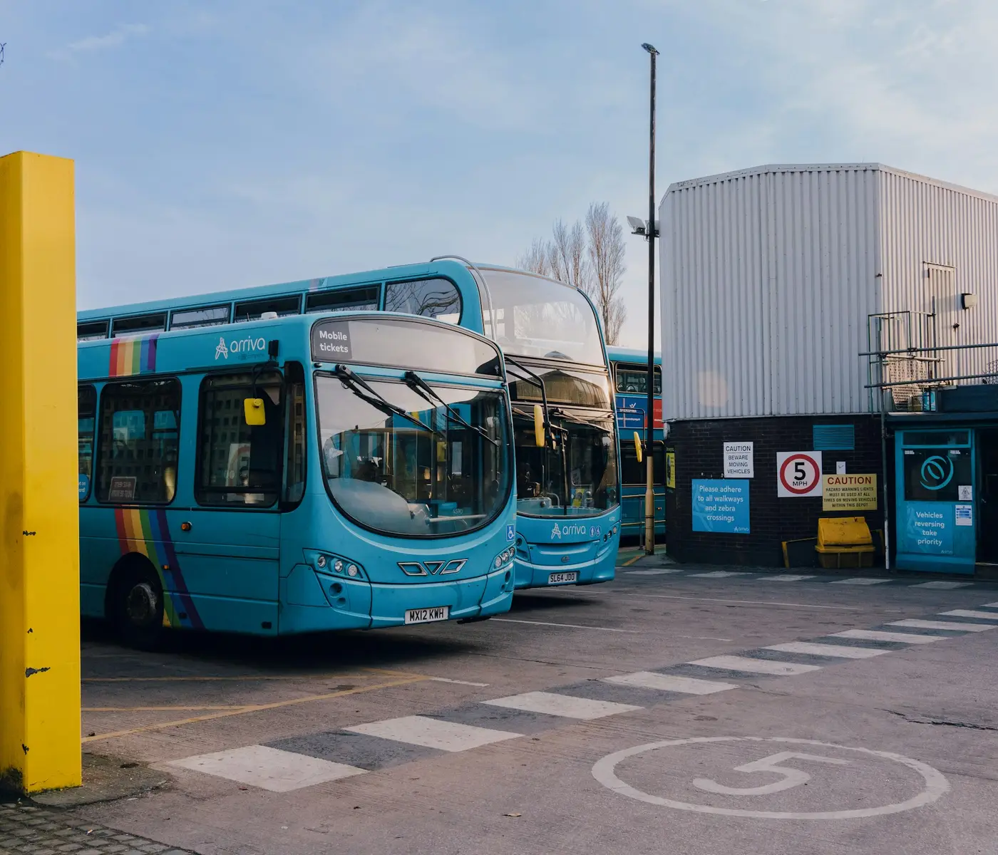Electric buses parked at a depot.